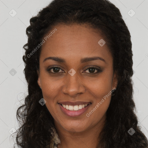 Joyful black young-adult female with long  brown hair and brown eyes