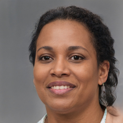 Joyful black adult female with short  brown hair and brown eyes