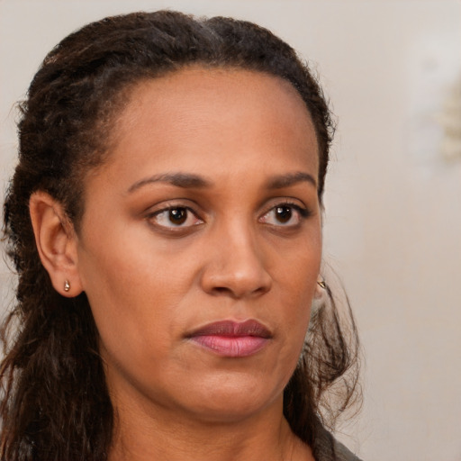 Joyful white adult female with long  brown hair and brown eyes