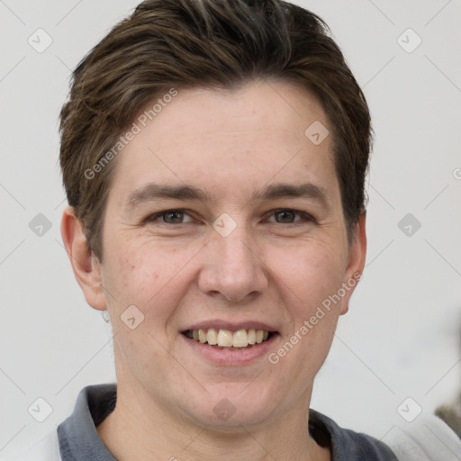 Joyful white adult male with short  brown hair and grey eyes