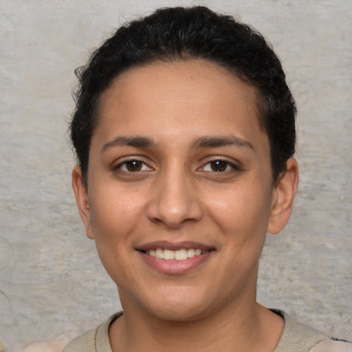 Joyful white young-adult female with short  black hair and brown eyes