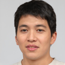 Joyful asian young-adult male with short  brown hair and brown eyes