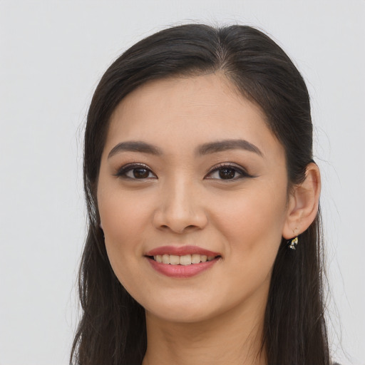 Joyful asian young-adult female with long  brown hair and brown eyes