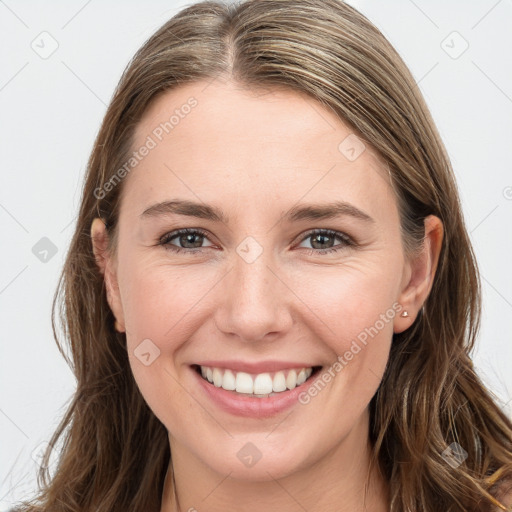 Joyful white young-adult female with long  brown hair and grey eyes