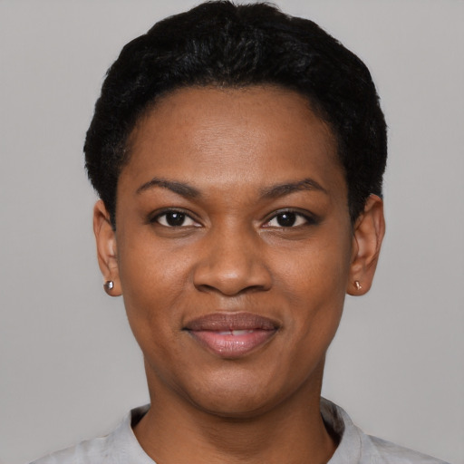 Joyful black young-adult female with short  black hair and brown eyes