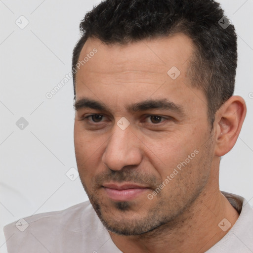 Joyful white adult male with short  brown hair and brown eyes