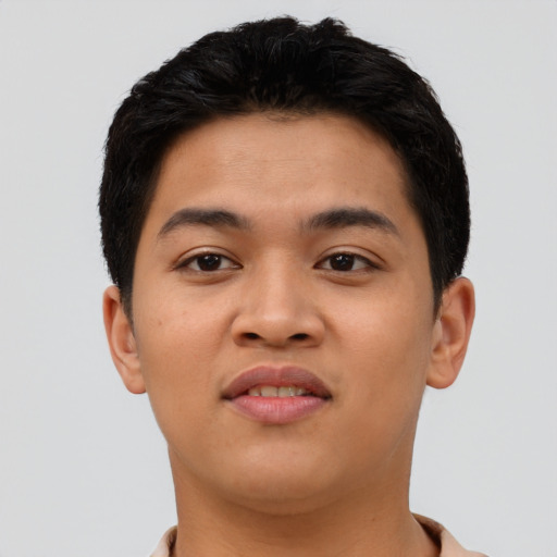 Joyful latino young-adult male with short  black hair and brown eyes