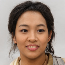 Joyful asian young-adult female with medium  brown hair and brown eyes