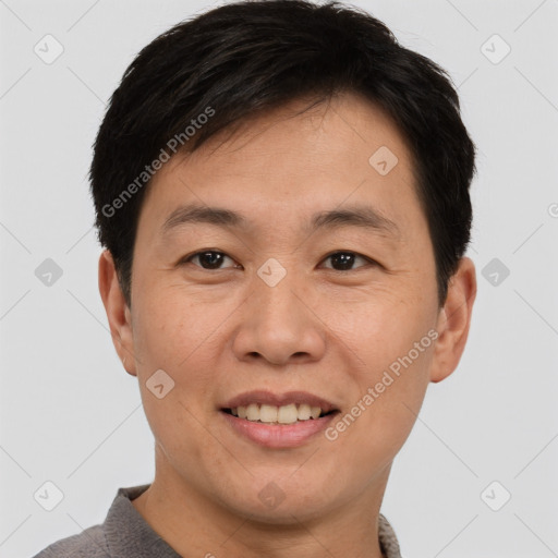 Joyful asian young-adult male with short  brown hair and brown eyes