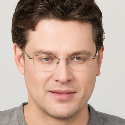 Joyful white adult male with short  brown hair and grey eyes