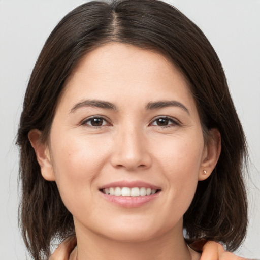 Joyful white young-adult female with medium  brown hair and brown eyes