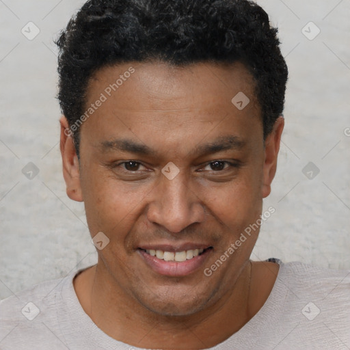 Joyful black adult male with short  brown hair and brown eyes