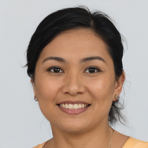 Joyful latino young-adult female with medium  brown hair and brown eyes
