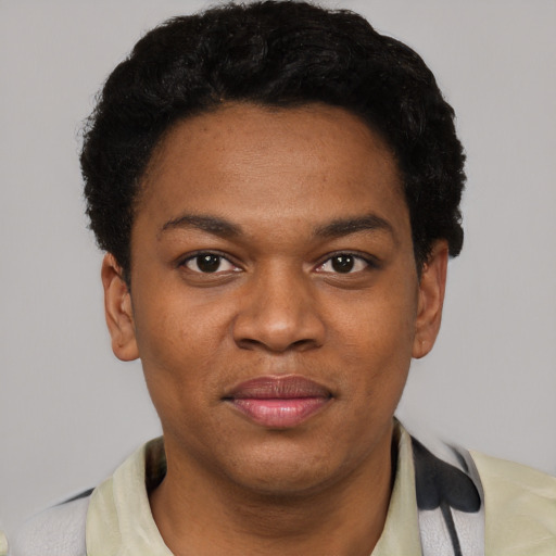 Joyful black young-adult female with short  black hair and brown eyes