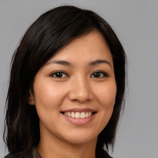 Joyful white young-adult female with long  brown hair and brown eyes