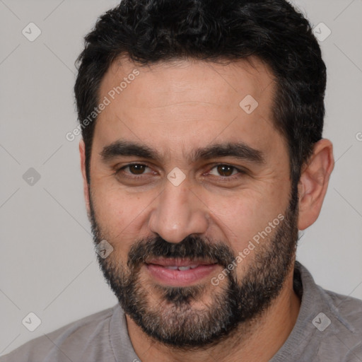 Joyful white adult male with short  black hair and brown eyes