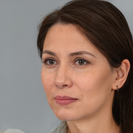 Joyful white adult female with medium  brown hair and brown eyes