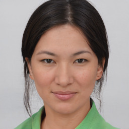 Joyful asian young-adult female with medium  brown hair and brown eyes