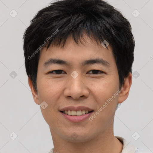 Joyful asian young-adult male with short  brown hair and brown eyes