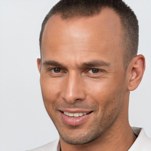 Joyful white adult male with short  brown hair and brown eyes