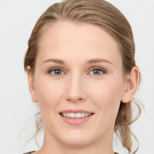 Joyful white young-adult female with medium  brown hair and blue eyes