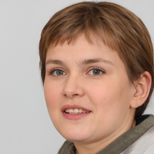 Joyful white young-adult female with medium  brown hair and blue eyes