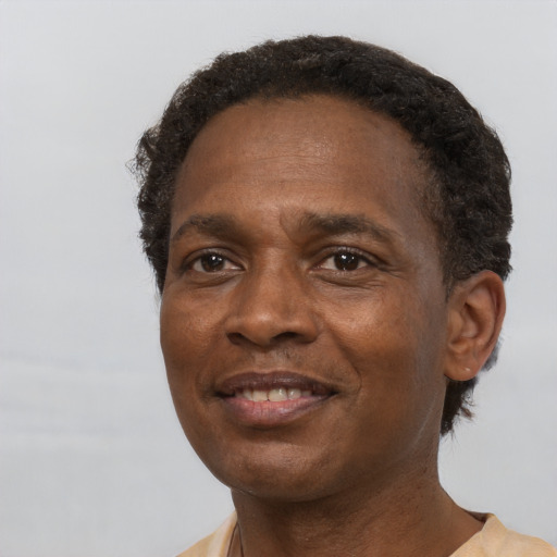 Joyful black adult male with short  brown hair and brown eyes