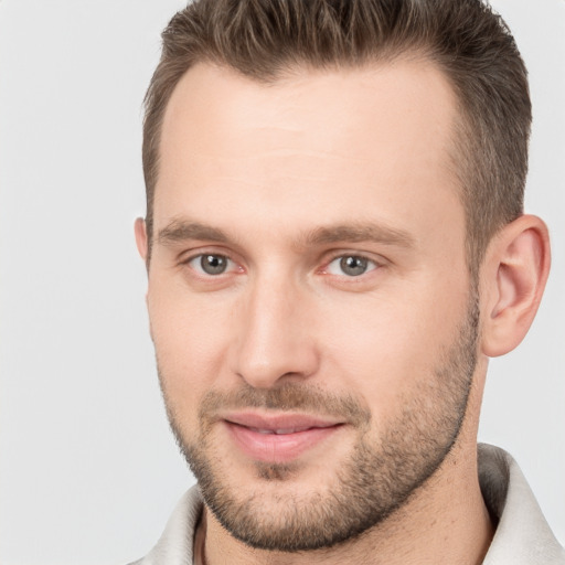 Joyful white young-adult male with short  brown hair and brown eyes