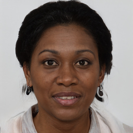 Joyful black adult female with medium  brown hair and brown eyes