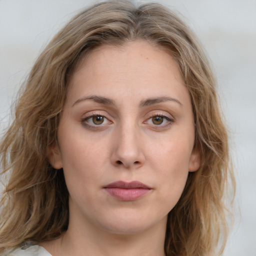 Joyful white young-adult female with medium  brown hair and blue eyes