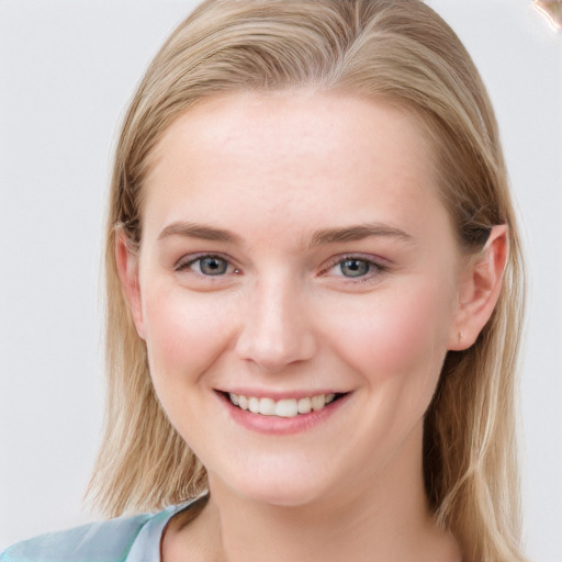 Joyful white young-adult female with long  brown hair and blue eyes