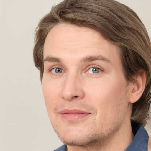 Joyful white adult male with short  brown hair and grey eyes