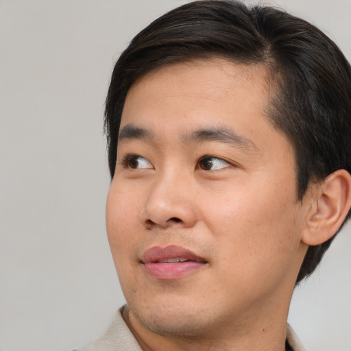 Neutral asian young-adult male with short  brown hair and brown eyes