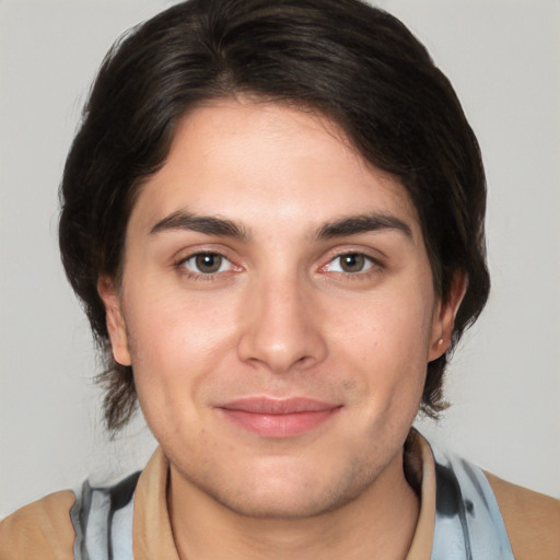 Joyful white young-adult male with medium  brown hair and brown eyes