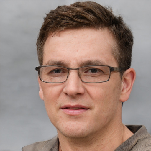 Joyful white adult male with short  brown hair and grey eyes