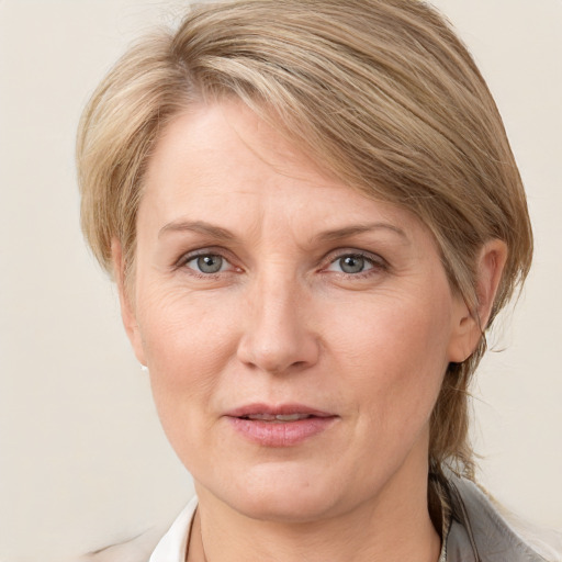 Joyful white adult female with medium  brown hair and grey eyes