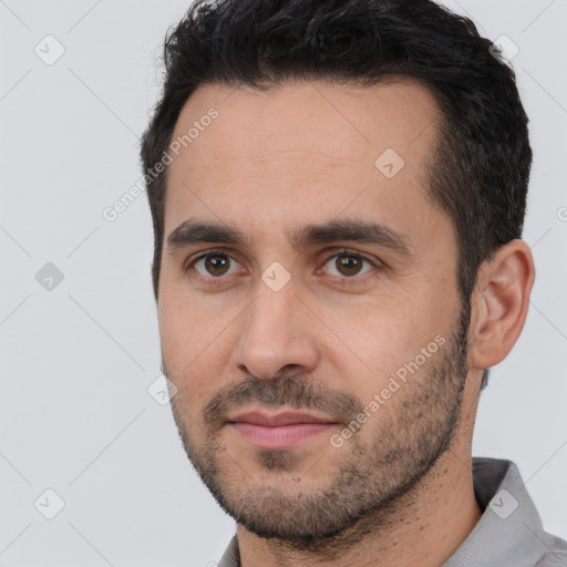 Joyful white young-adult male with short  black hair and brown eyes