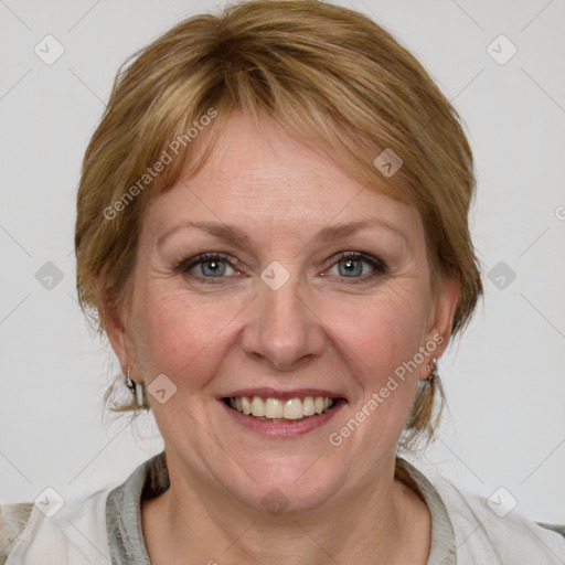 Joyful white adult female with medium  brown hair and blue eyes