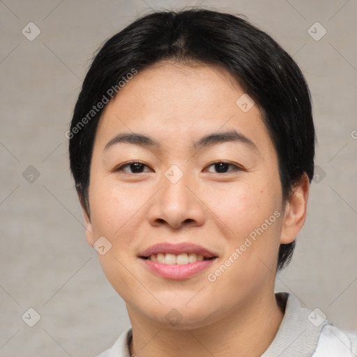 Joyful asian young-adult female with short  black hair and brown eyes