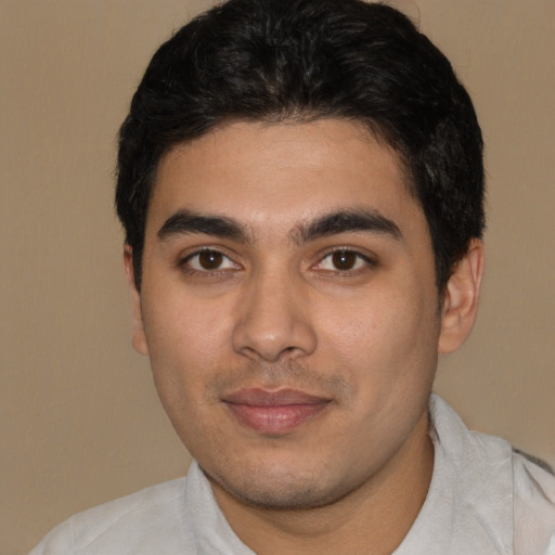 Joyful latino young-adult male with short  black hair and brown eyes