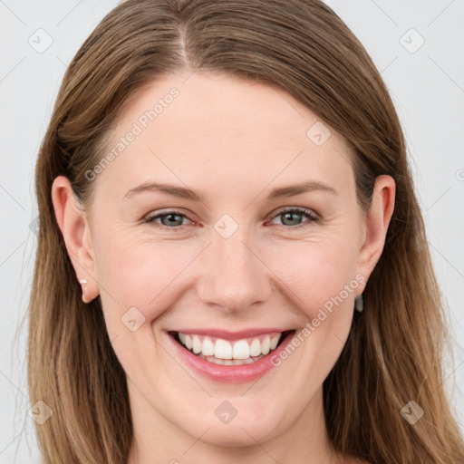 Joyful white young-adult female with long  brown hair and blue eyes