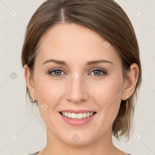 Joyful white young-adult female with medium  brown hair and grey eyes