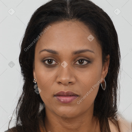 Joyful black young-adult female with long  brown hair and brown eyes
