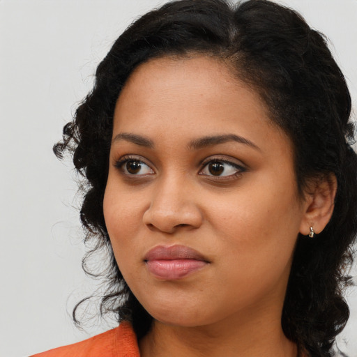 Joyful latino young-adult female with medium  black hair and brown eyes