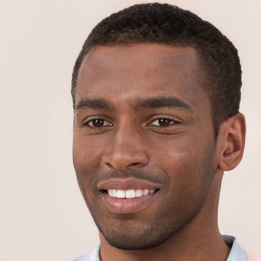 Joyful black young-adult male with short  brown hair and brown eyes