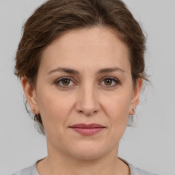 Joyful white adult female with medium  brown hair and brown eyes