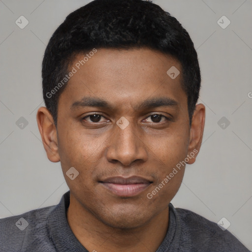 Joyful black young-adult male with short  black hair and brown eyes