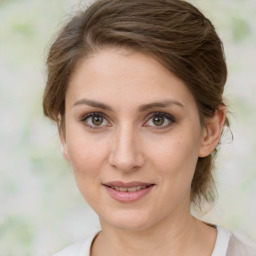 Joyful white young-adult female with medium  brown hair and green eyes