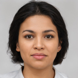 Joyful latino young-adult female with medium  brown hair and brown eyes