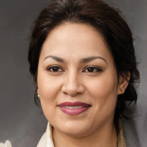 Joyful white adult female with long  brown hair and brown eyes